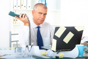 Stressed businessman sitting at desk